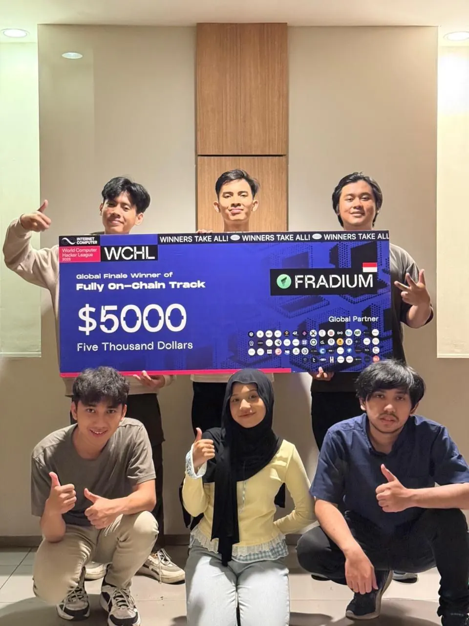 Six Fradium teammates pose around a board naming the team Global Finale winner of the Fully On-Chain Track.